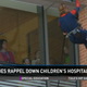 Illustration for article titled SWAT Team Members in Superhero Costumes Go Rappelling for Sick Kids